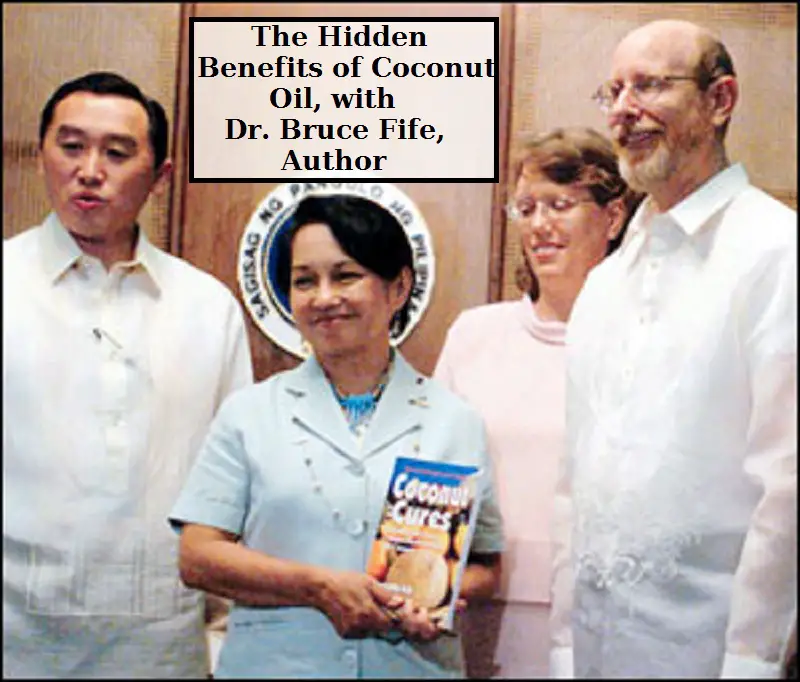 Dr. Bruce Fife presents a copy of his book on Coconut Oil cures. 