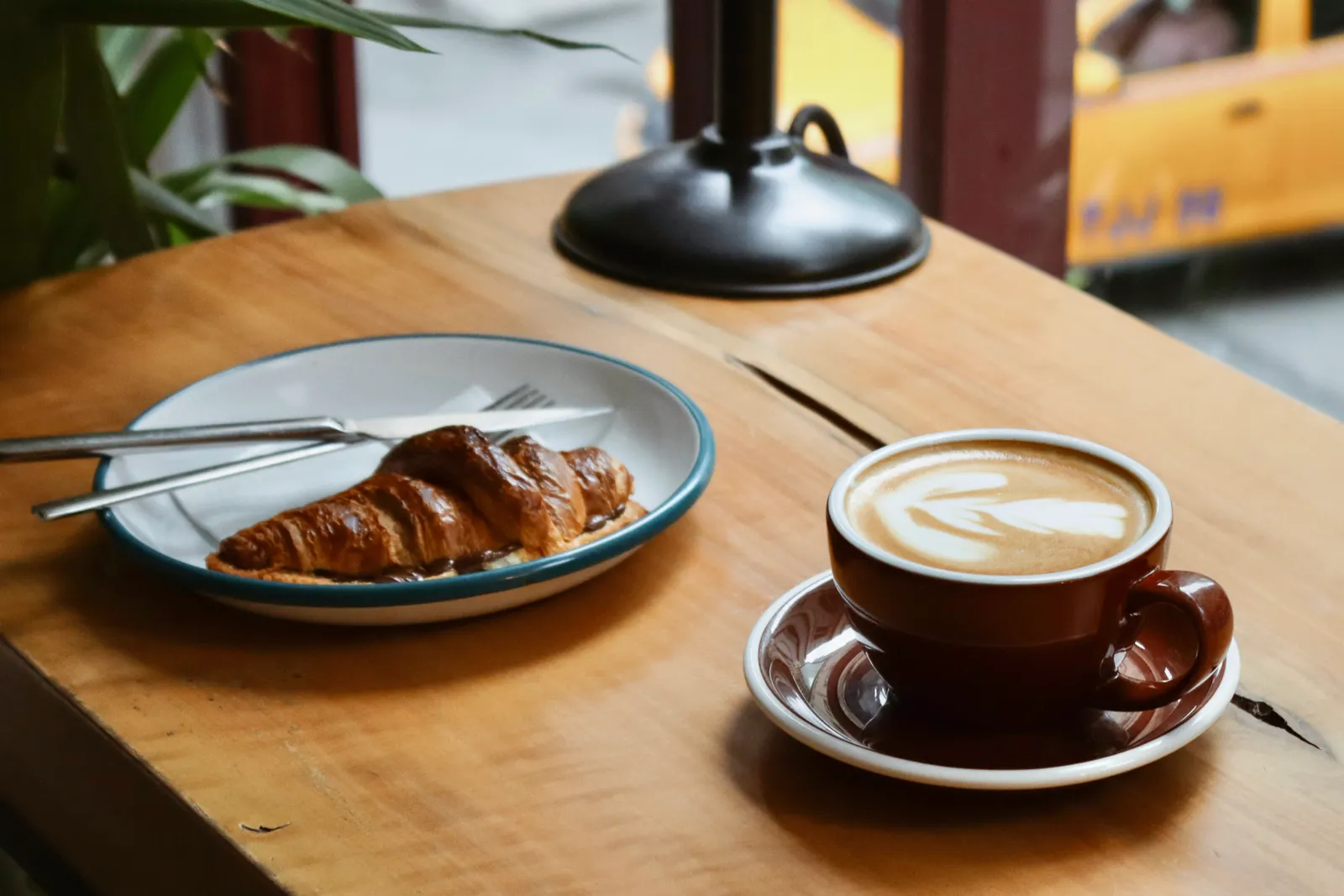 Croissant and coffee on a café table