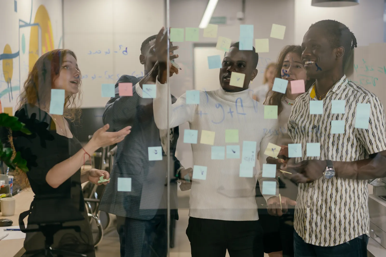 Planning session around a wall of sticky notes