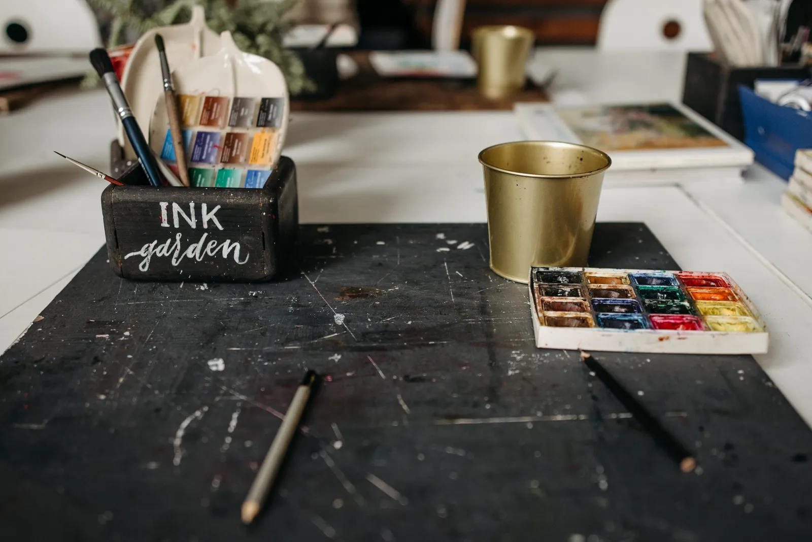 Desk in the studio with paints and brushes