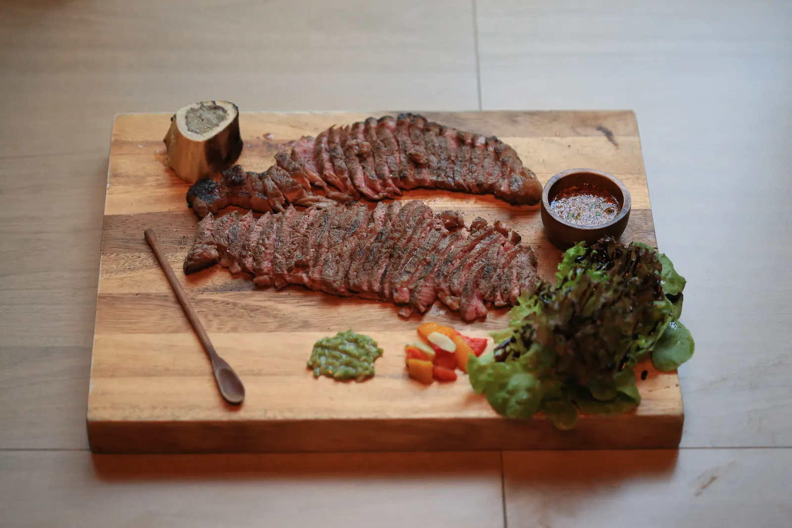 Sliced steak on a wooden board