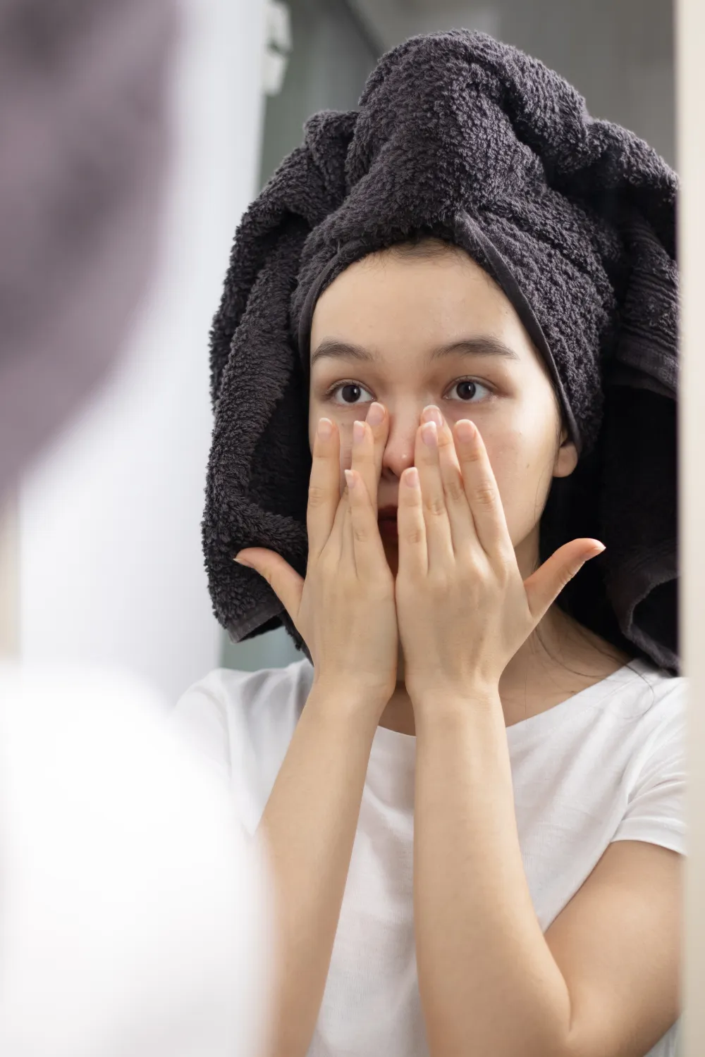 Woman touching her face after skincare