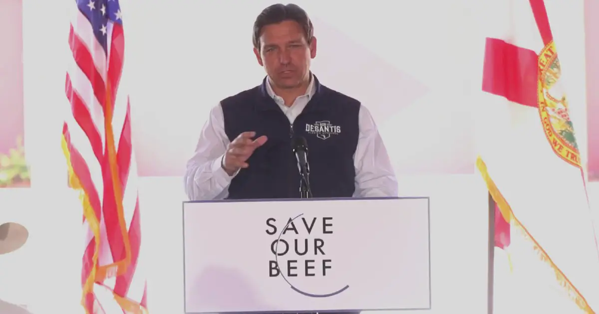Ron DeSantis on a podium during a frenzy of activity that led to the banning or lab grown meat. 